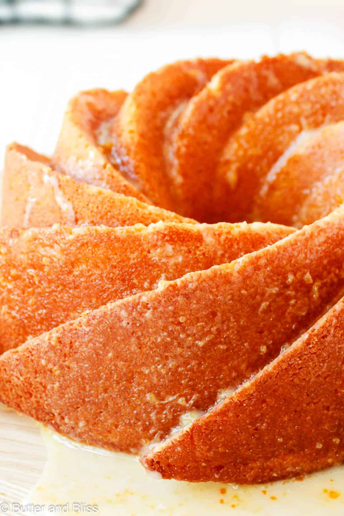 Close up of a whole orange butter cake made in a heritage bundt pan.