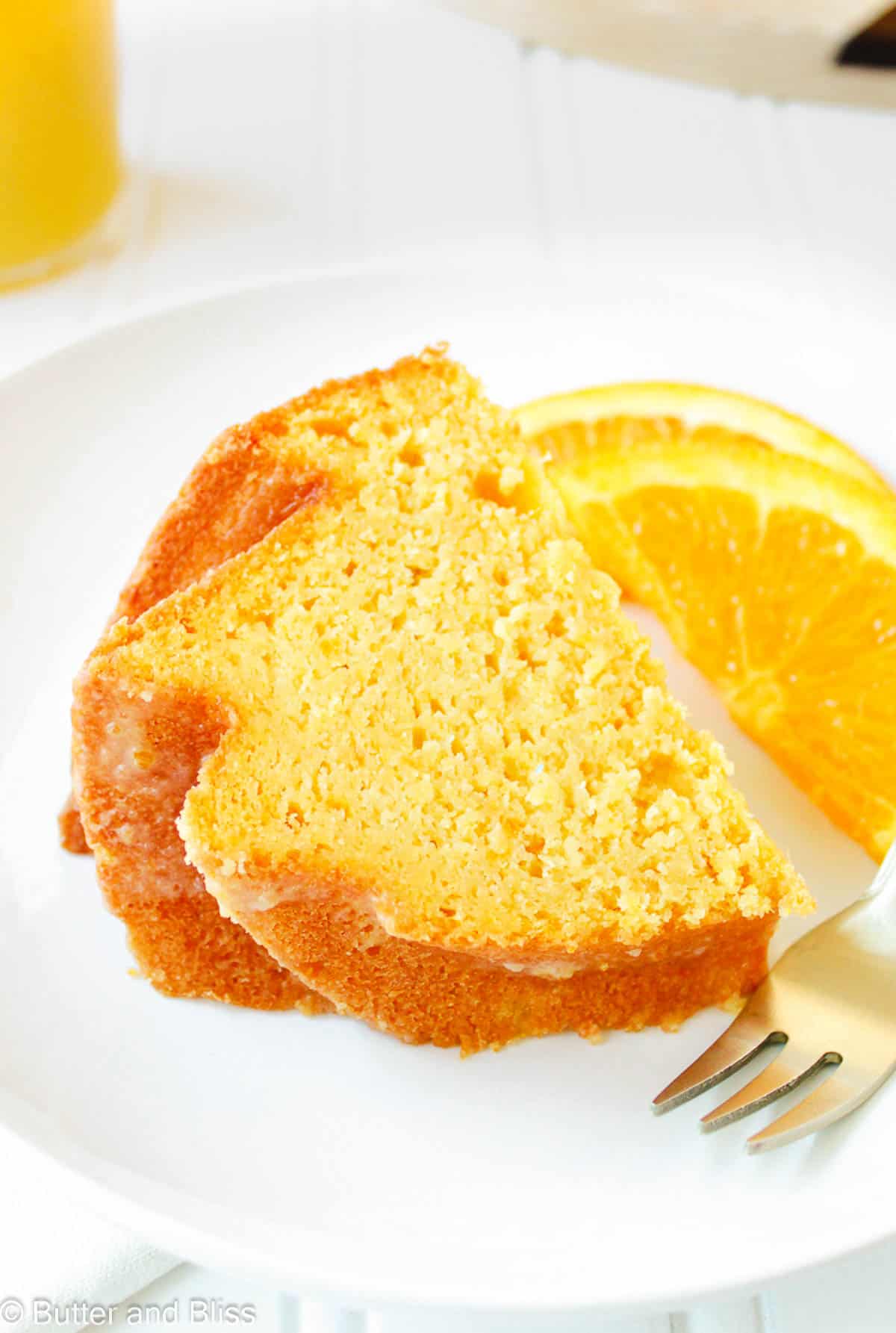 Super moist citrus cake slice on a white plate.