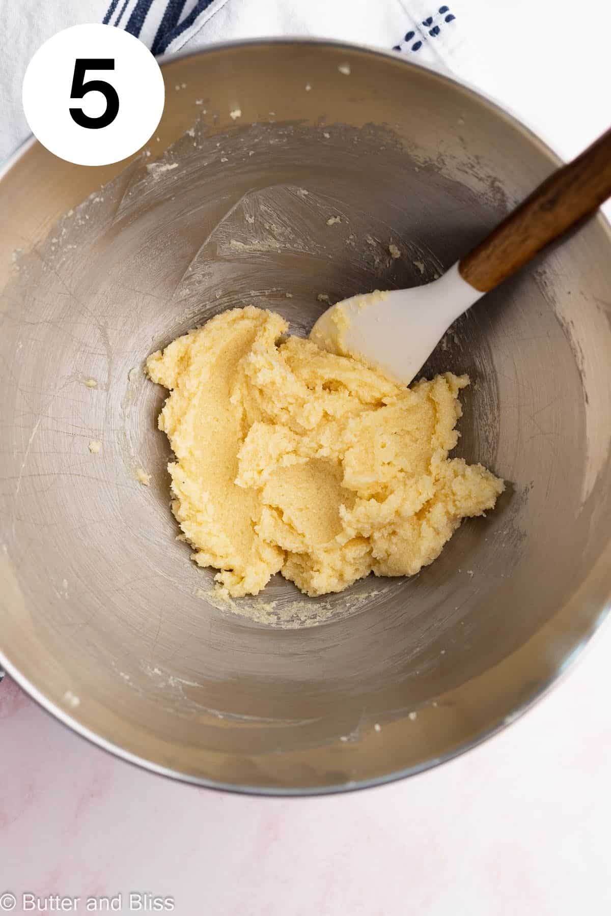Butter and sugar that have been creamed in a mixing bowl.