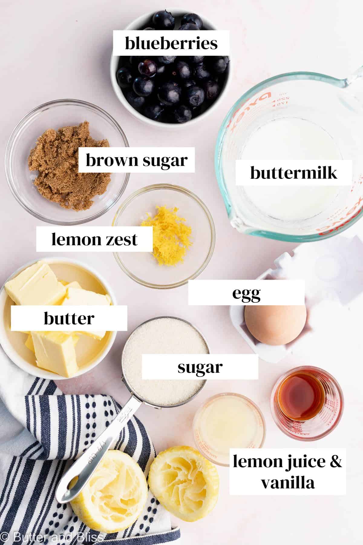 Wet ingredients for a butter cak in small bowls arranged on a table.