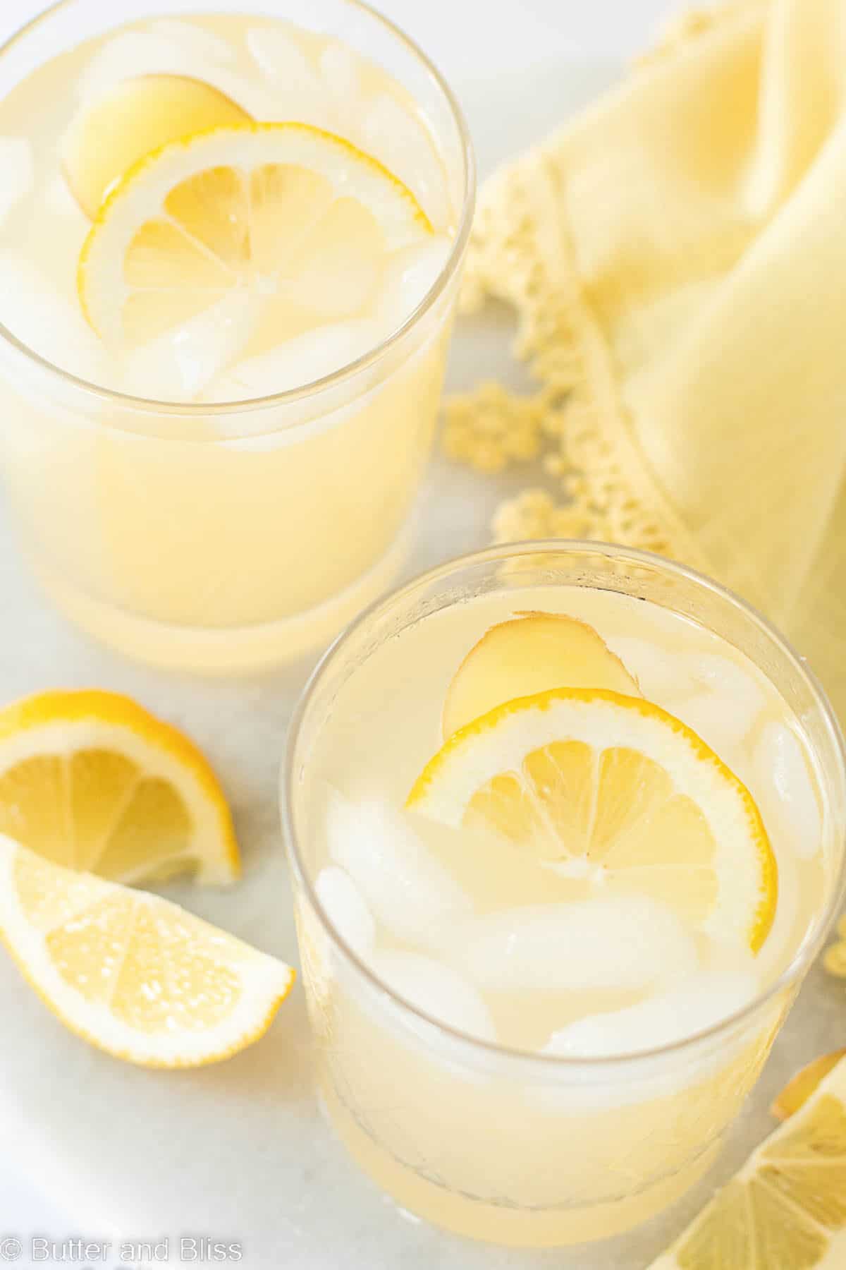 Inside photo of two glasses of ginger lemonade on ice