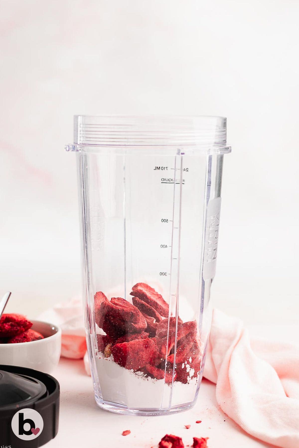 Freeze dried strawberries and powdered sugar in a small blender.