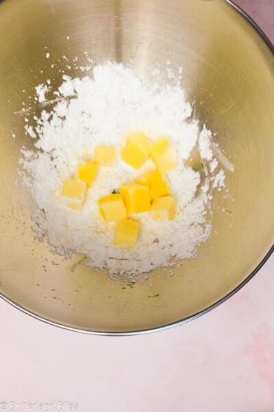 Powdered sugar and butter in a mixing bowl.