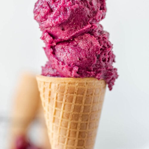 No churn cherry ice cream scooped on an ice cream cone