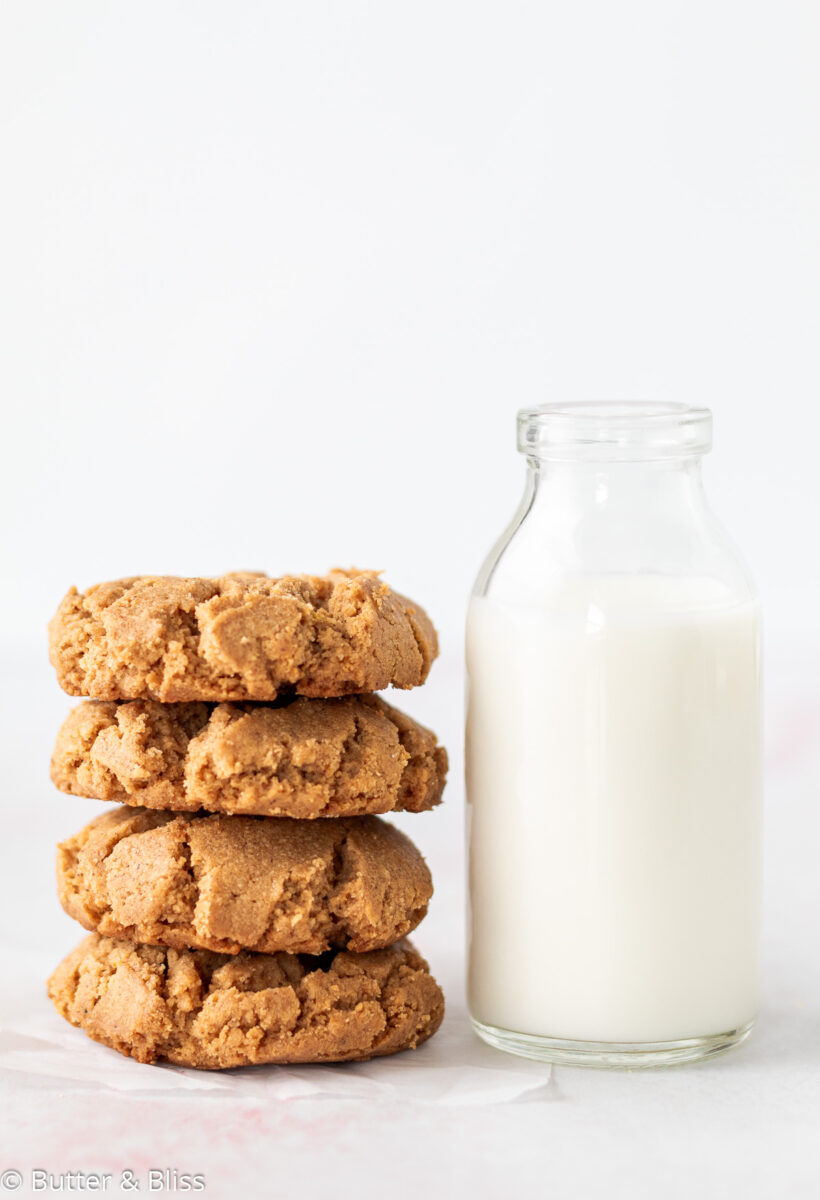 Stack of peanut butter cookies next to milk glass