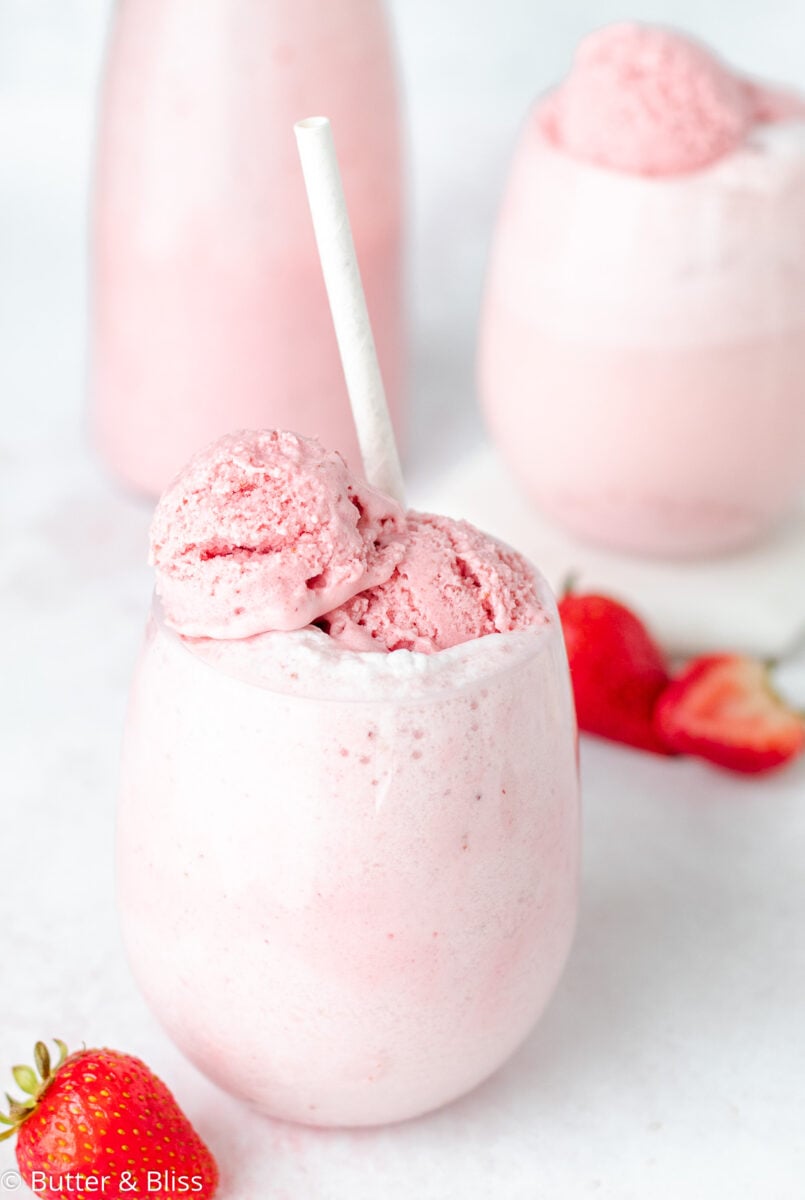 A glass of strawberry ice cream float