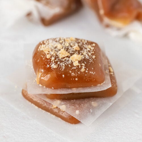 Close up of apple cider caramel candy topped with ginger.