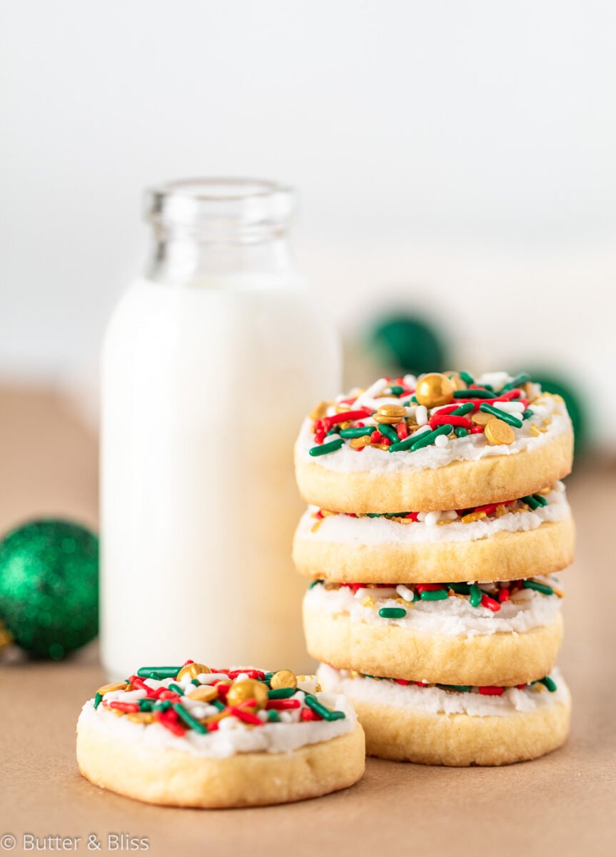 Frosted butter cookies with a glass of milk