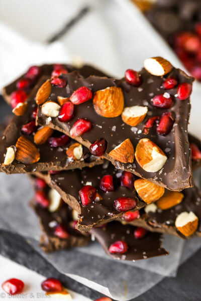 Close up of a piece of dark chocolate bark with pomegranate