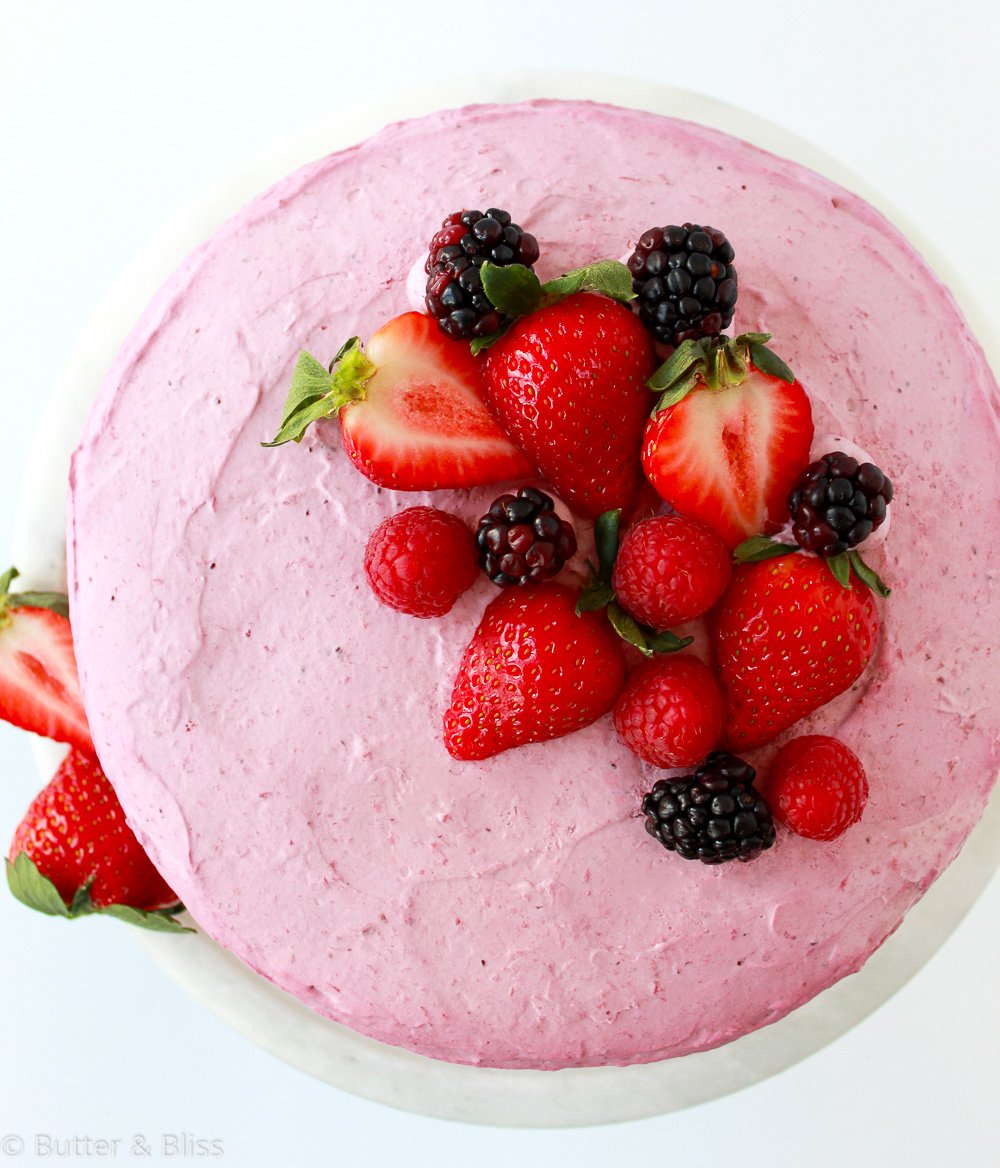 Top view of berry mousse layer cake with fresh berries