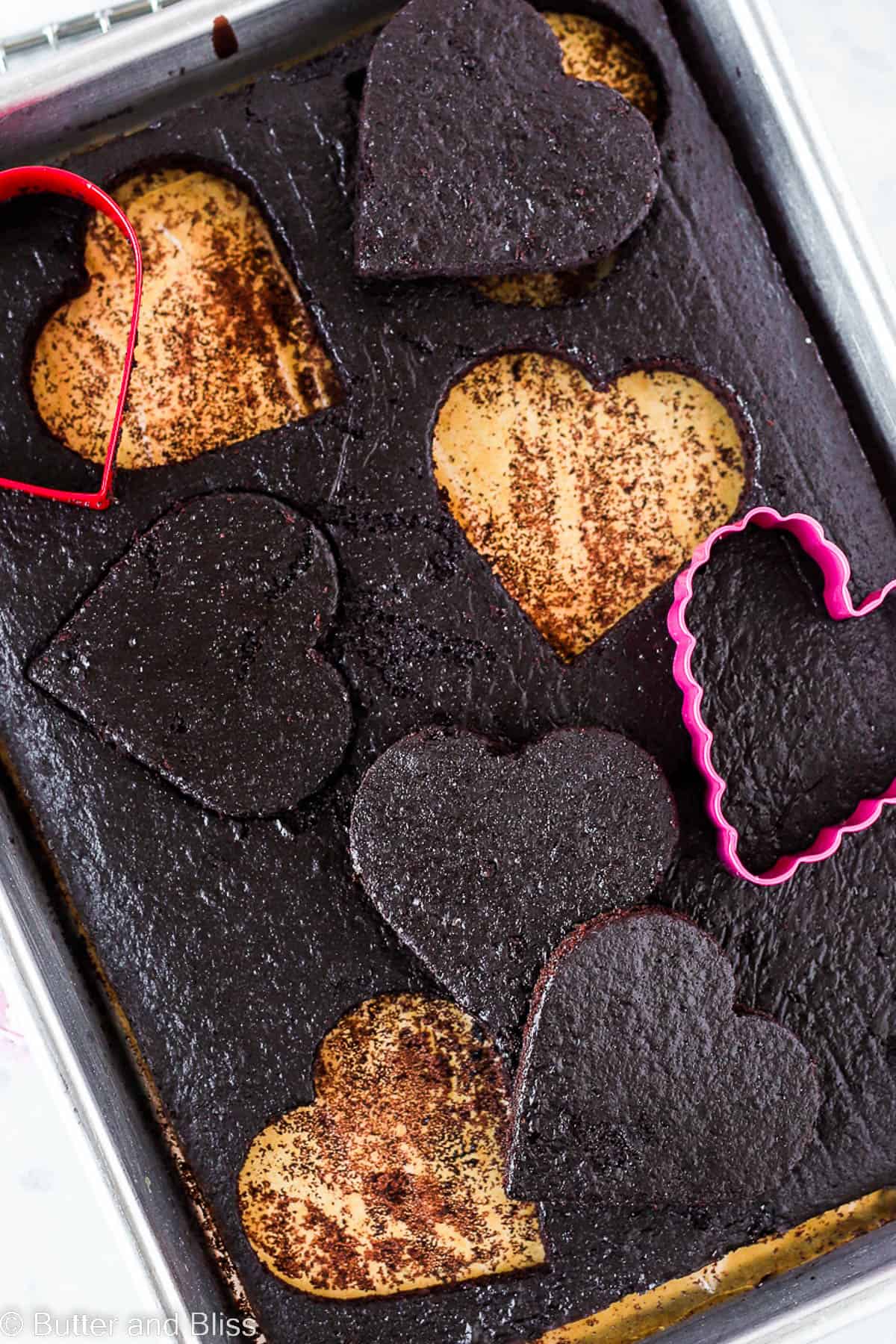 A pan of cake cut into holiday shaped pieces.