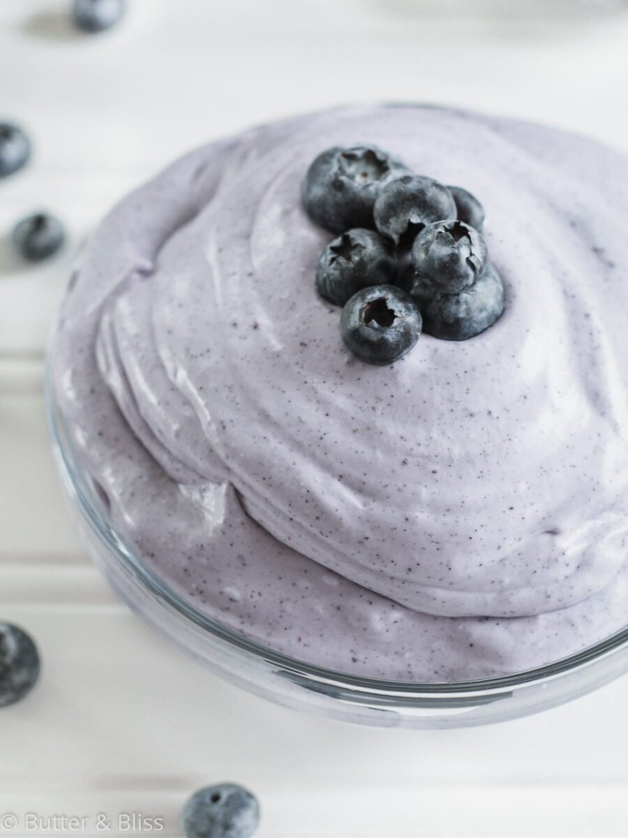Whipped coconut cream with blueberries in a bowl