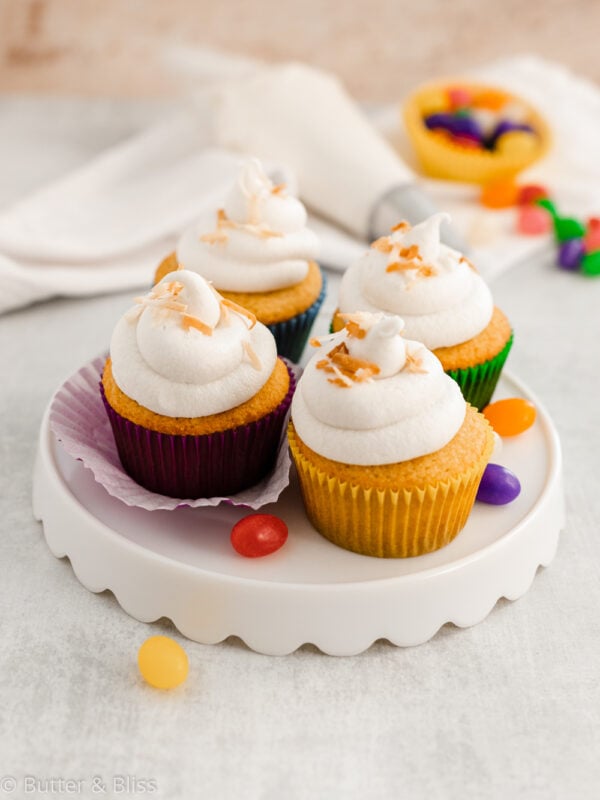 Frosted Easter cupcakes on a platter with jelly beans