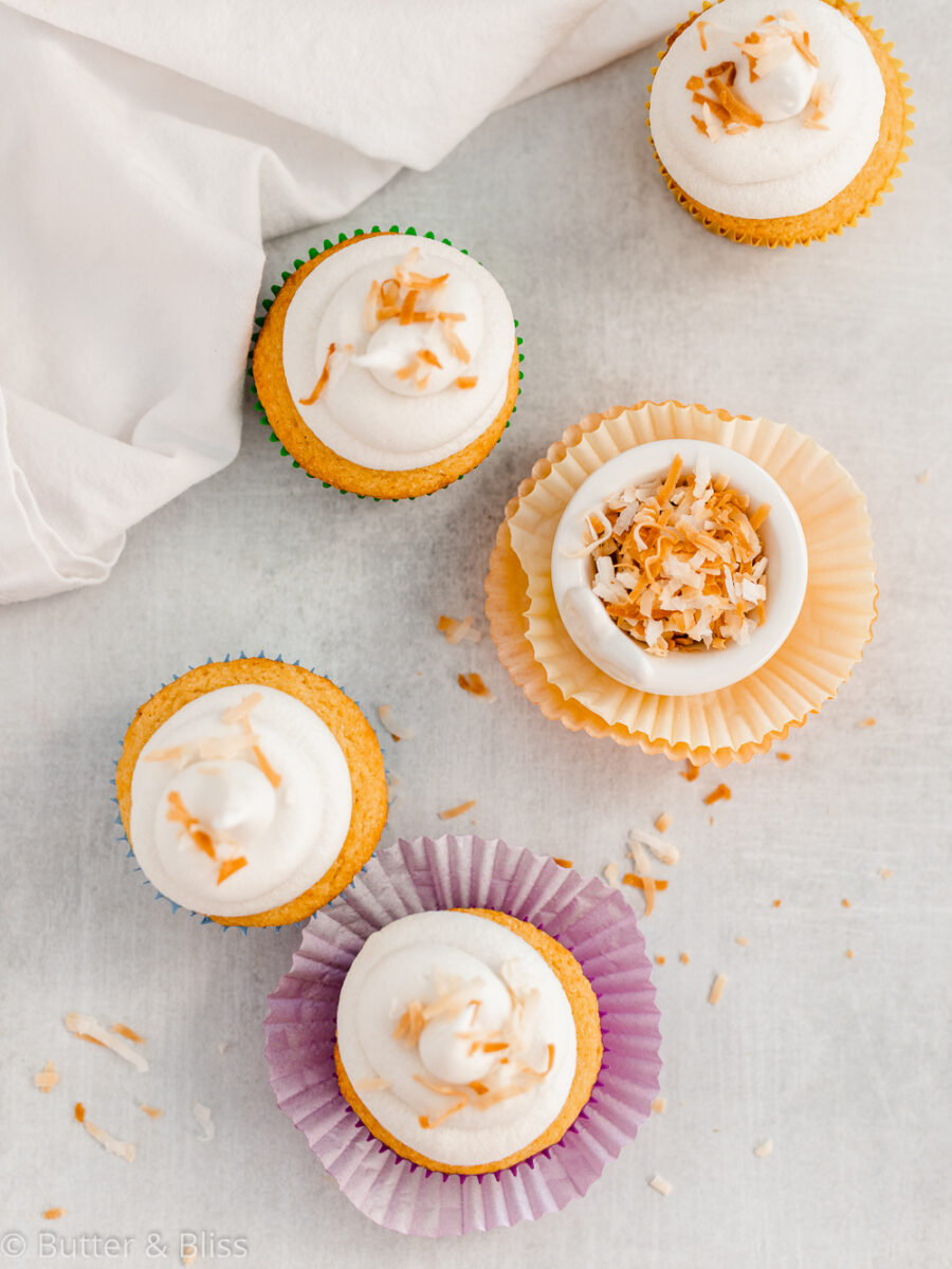 4 vanilla cupcakes on a table