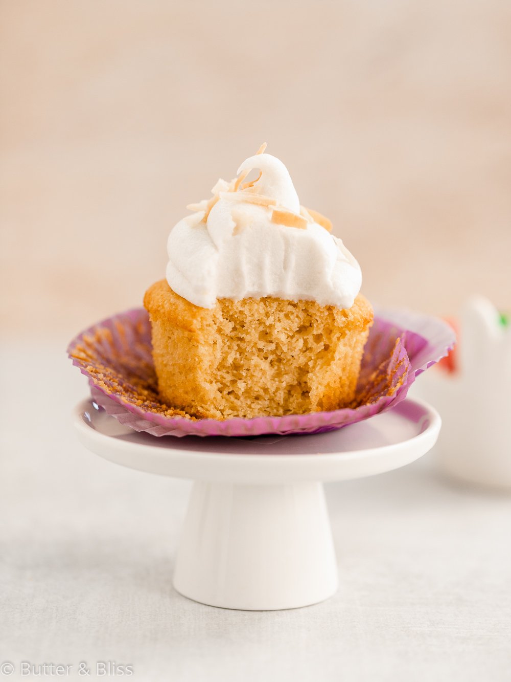 Gluten free vanilla cupcake with a bite