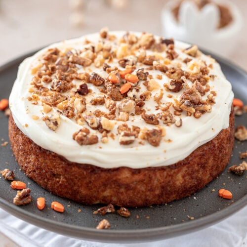 Frosted carrot cake on a serving platter