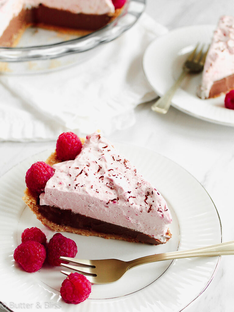 Chocolate cream pie with raspberry cream on a plate