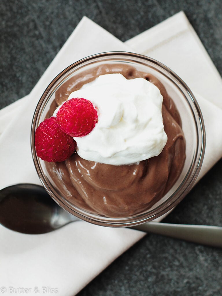 Chocolate pudding in a bowl with whipped topping