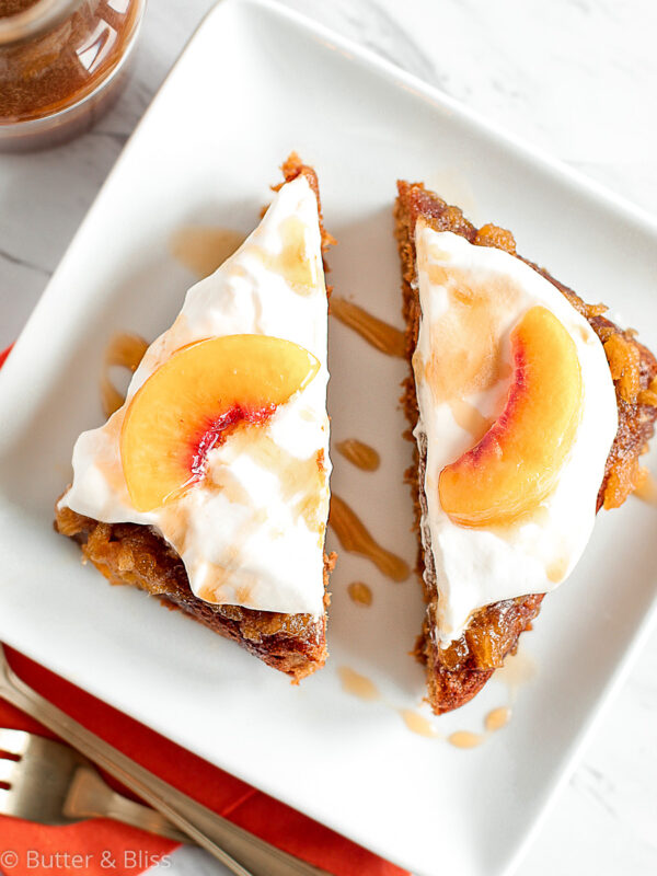 Two slices of peach caramel cake on a plate