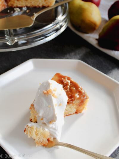 Single slice of pear upside down cake with whipped cream