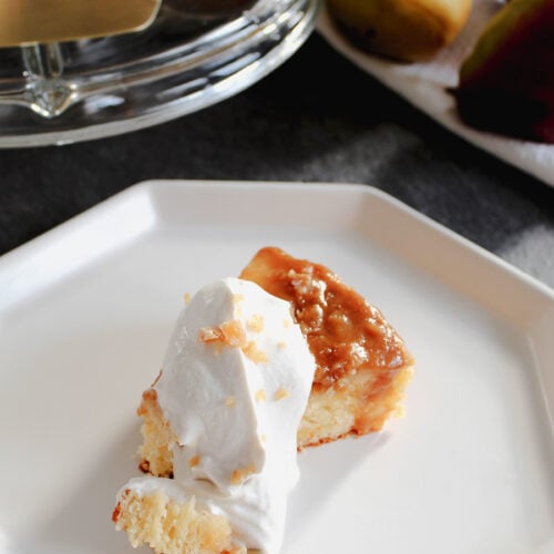 Single slice of pear upside down cake with whipped cream