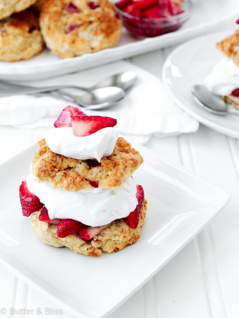 Strawberry shortcake on a plate with whipped cream