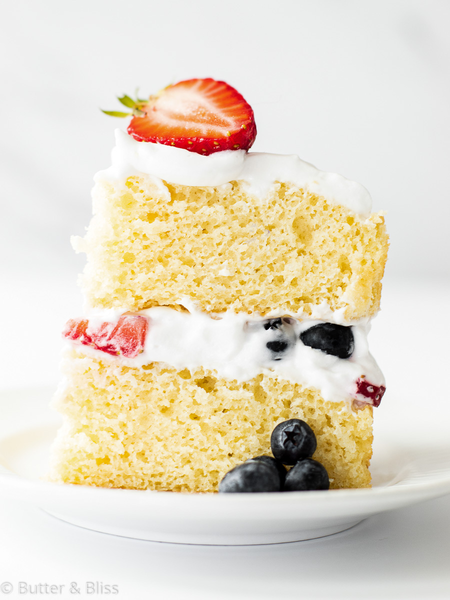 Fresh berry and vanilla cake slice on a plate
