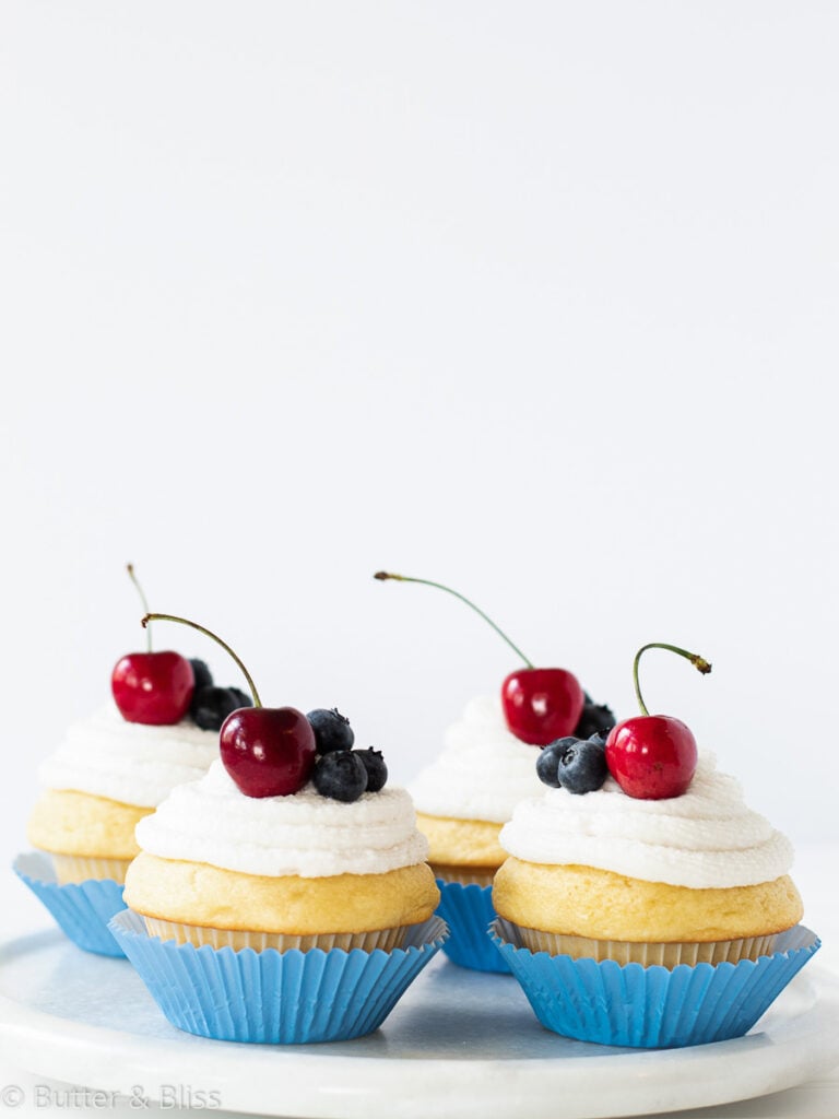 Double vanilla cupcakes on a platter