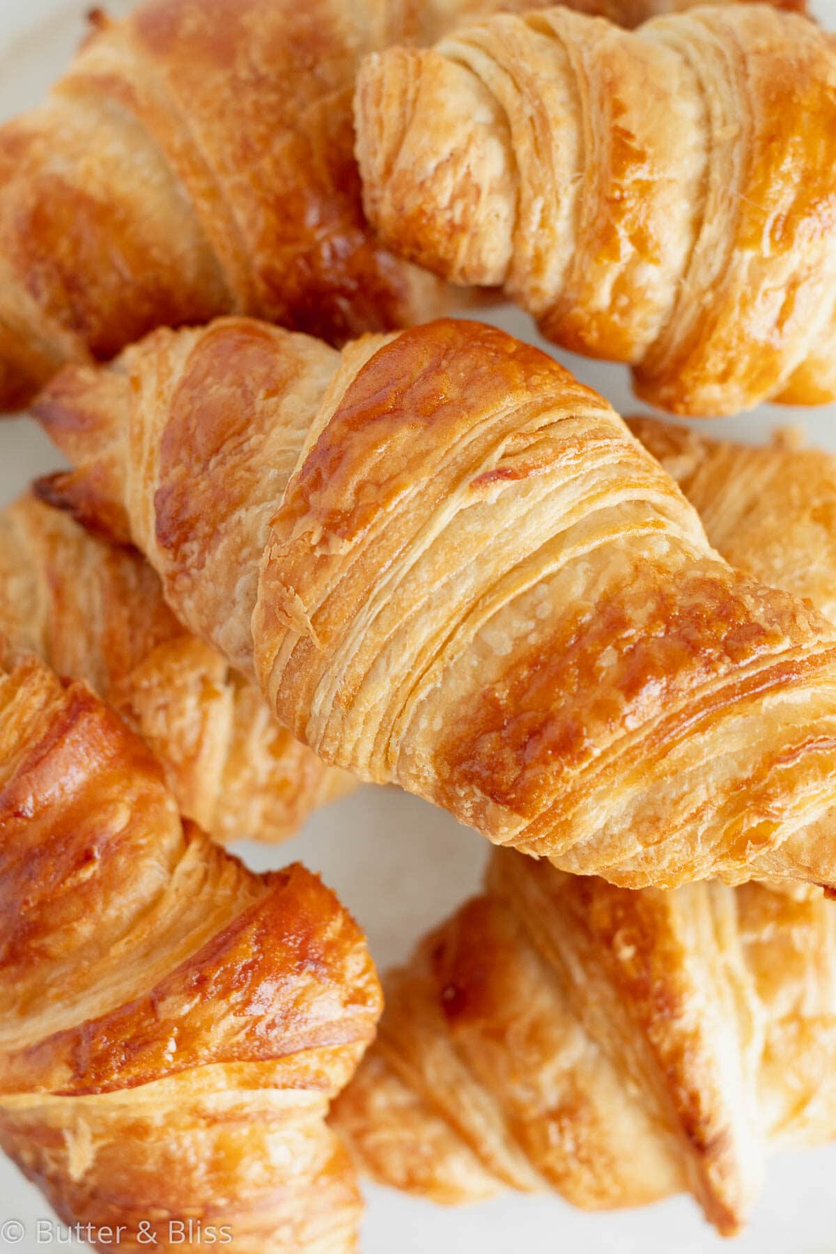 Close up of flaky layers of a homemade croissant.