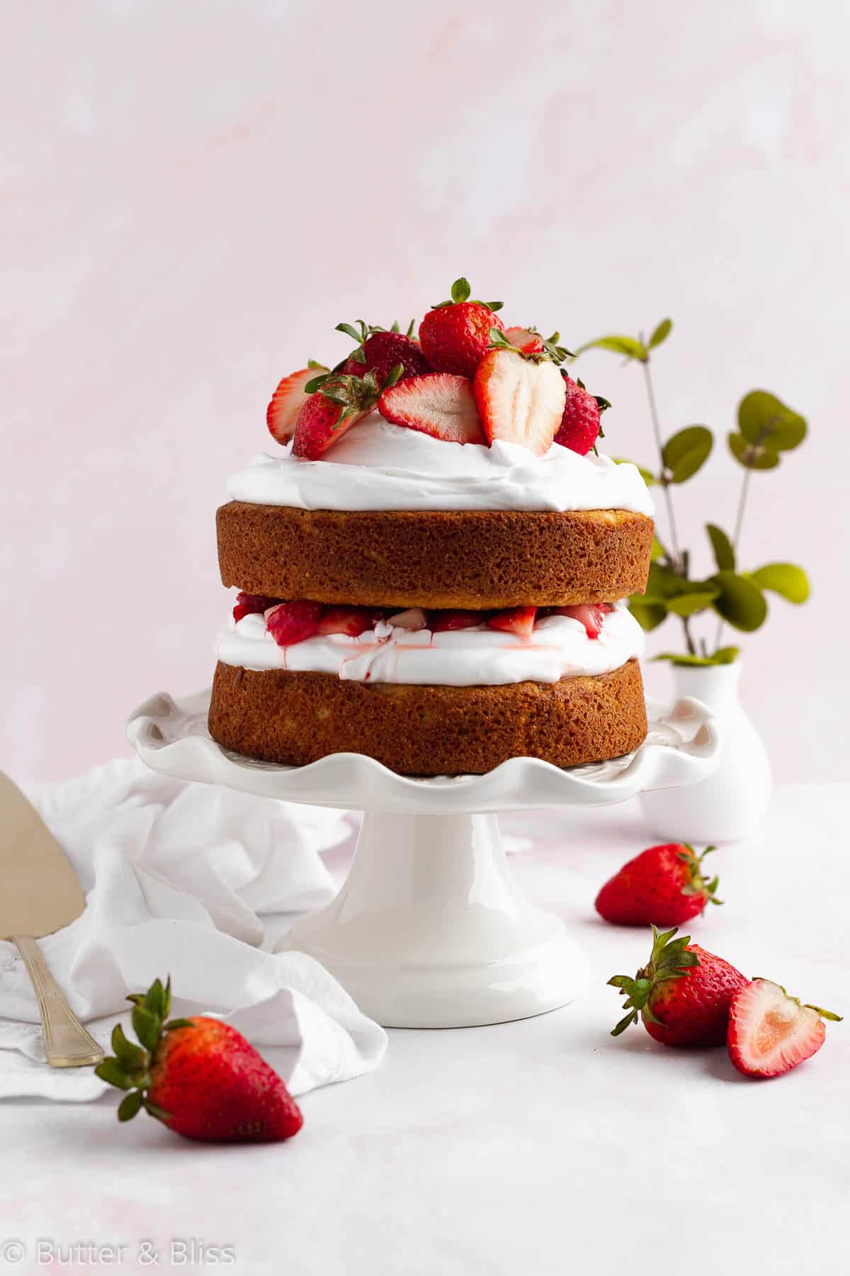 Strawberry shortcake layer cake on a cake platter