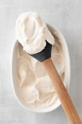 Butter free vanilla frosting in a bowl and covered on a spatula.