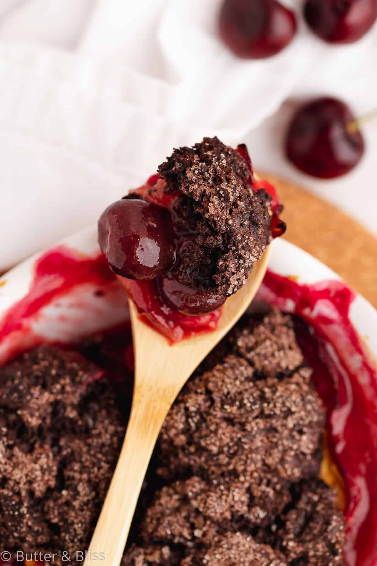 Chocolate stone fruit cobbler close up on a spoon