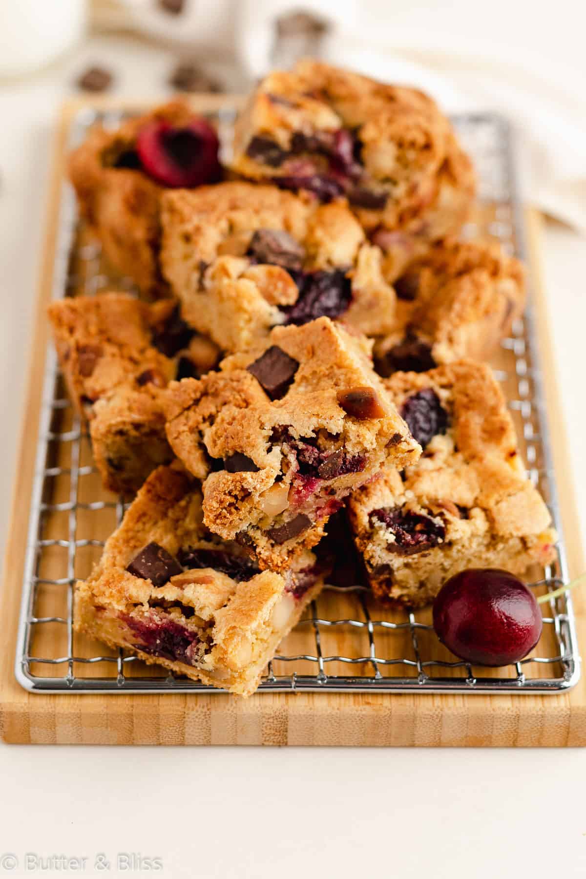 Gluten free cherry blondies cut into squares on a wire rack