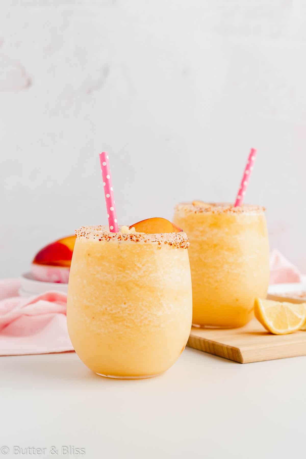 Two peach and citrus refreshers in small glasses