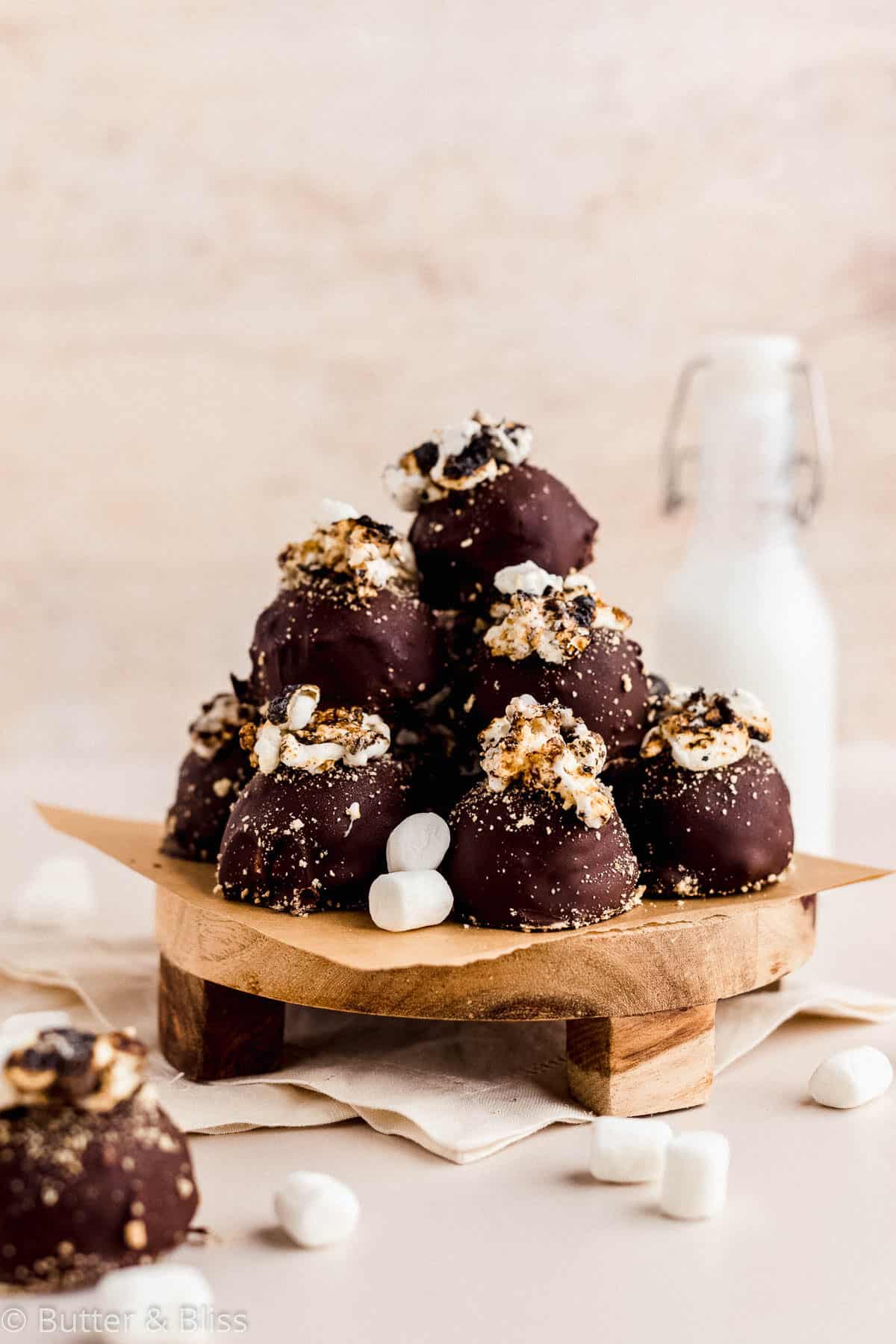 Stack of toasty s'mores truffles on small cake stand