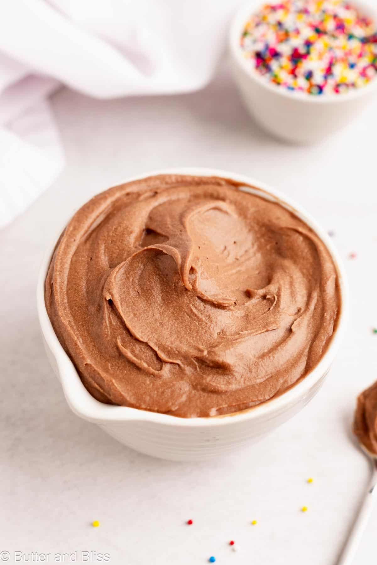 Small white bowl full of chocolate butter free frosting.