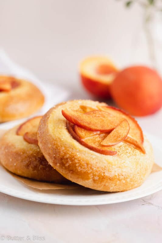 A peach and custard mini pie on a plate