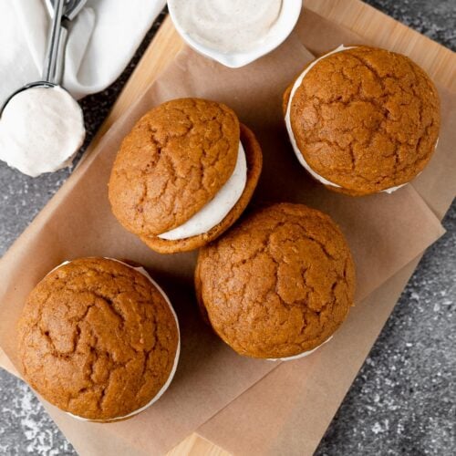 Pumpkin spice whoopie pies on a cutting board