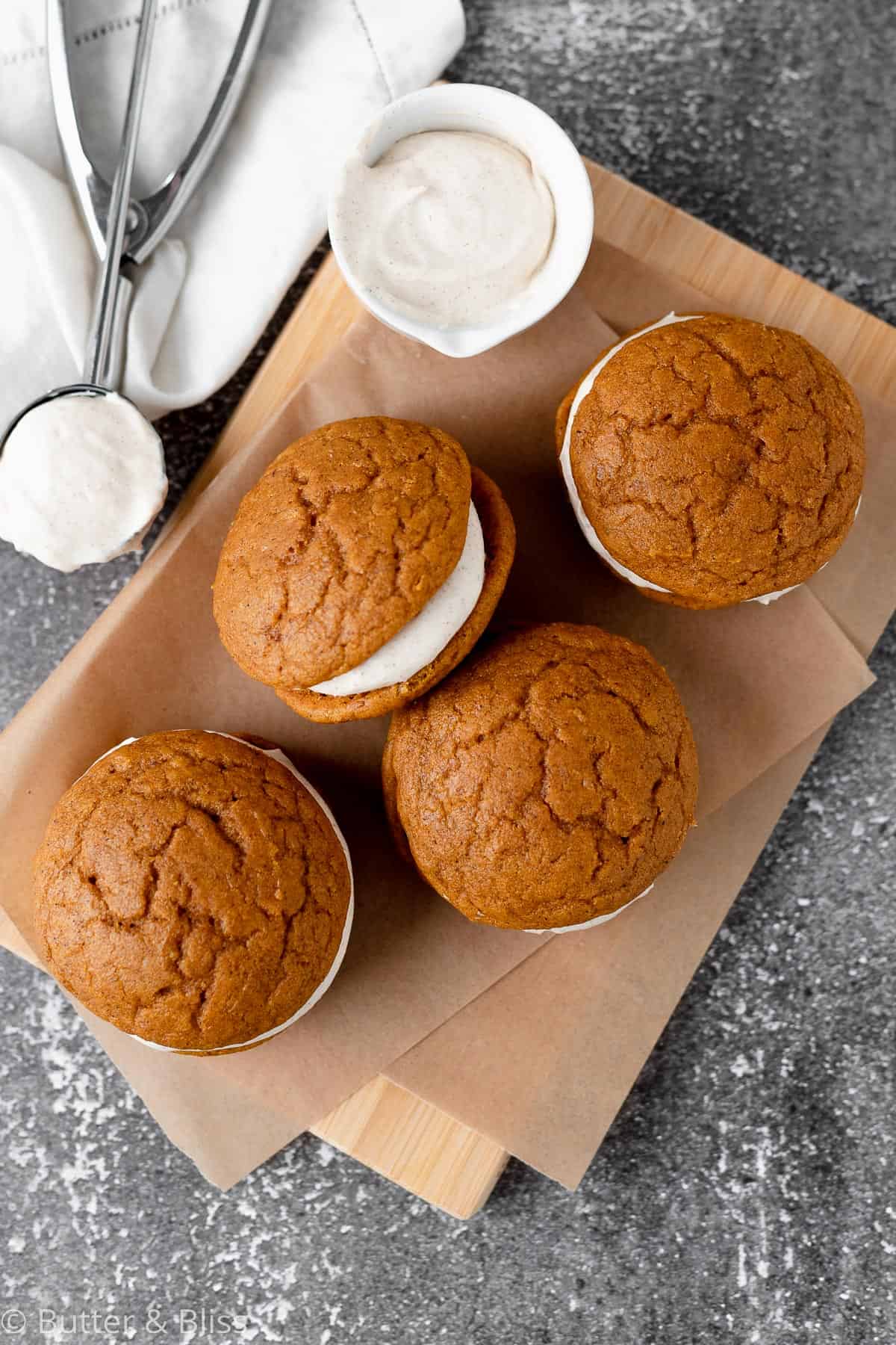 Pumpkin spice whoopie pies on a cutting board