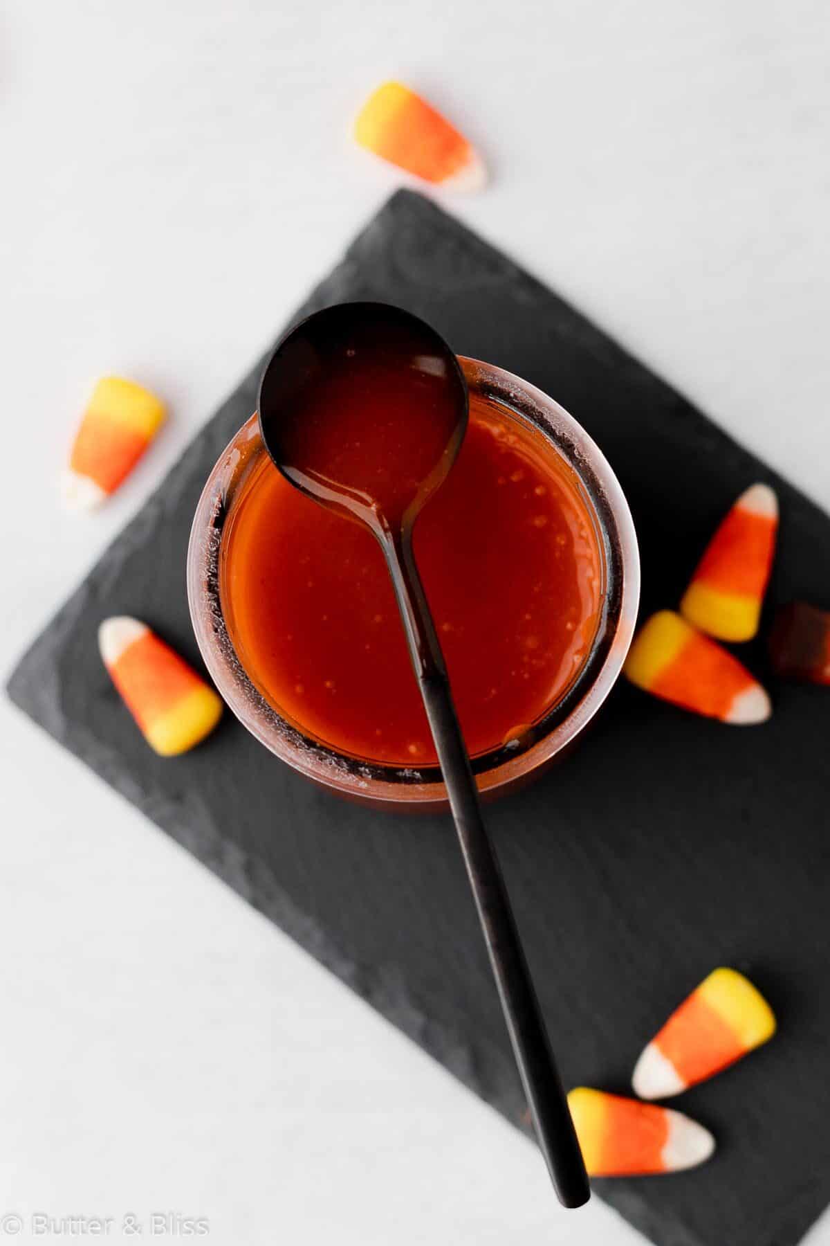 Halloween candy corn made into a caramel sauce in a jar