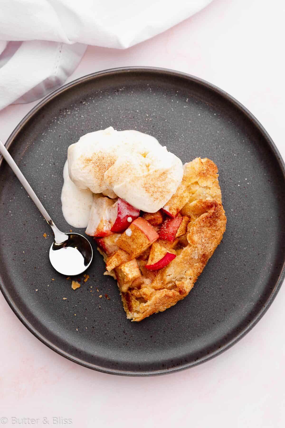 Slice of caramel corn apple galette on a plate with ice cream