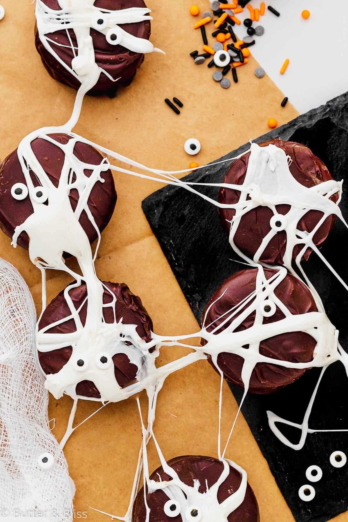 Chocolate halloween cookies with marshmallow web and sprinkles