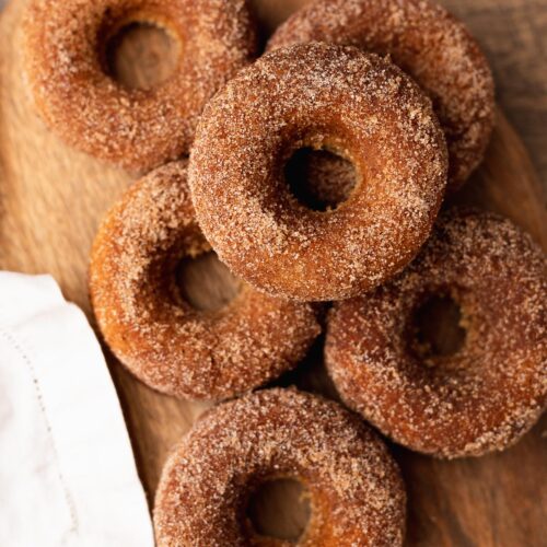 Freshly baked apple cider donuts on cutting board