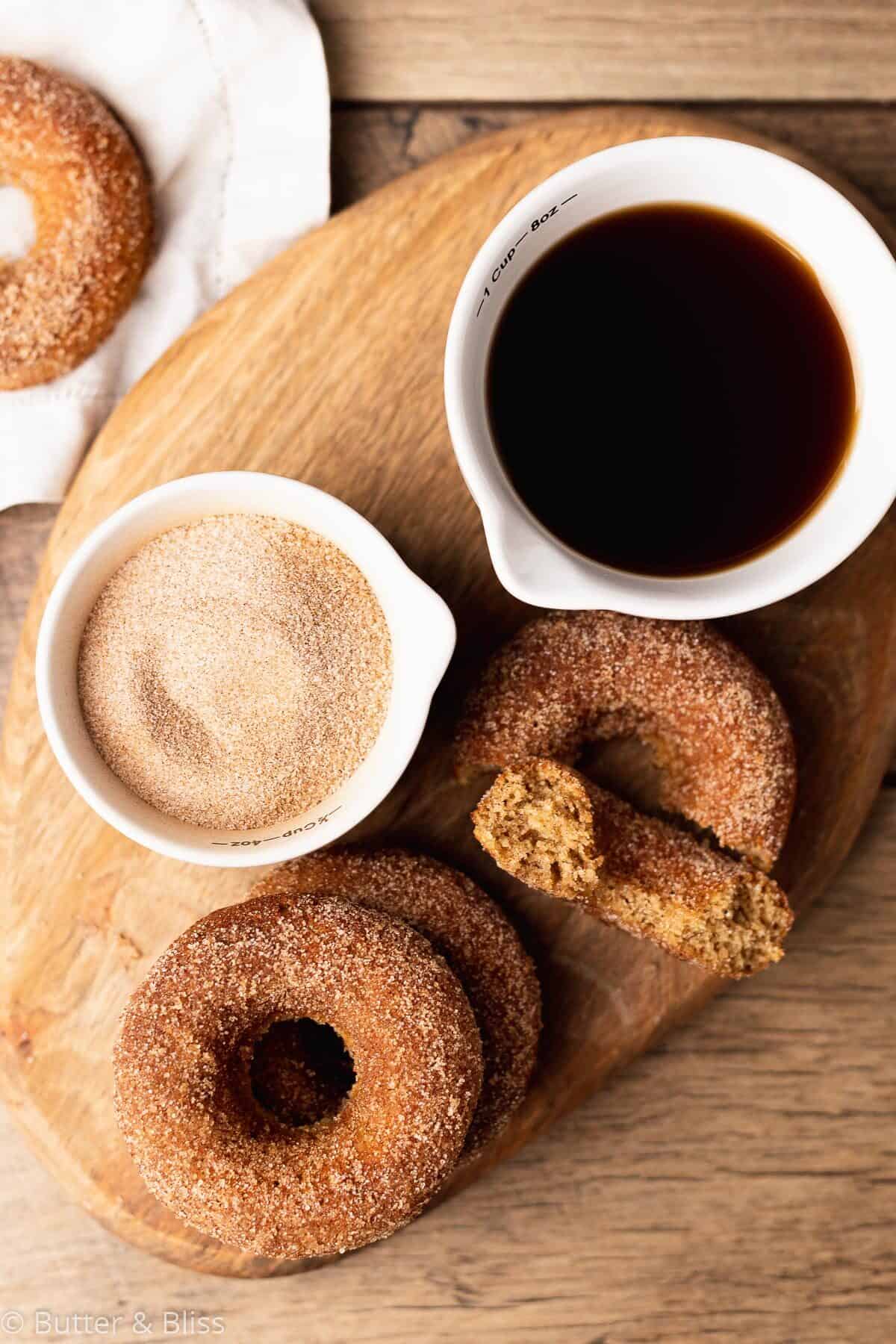 Gluten free apple cider donuts on a tray with ingredients