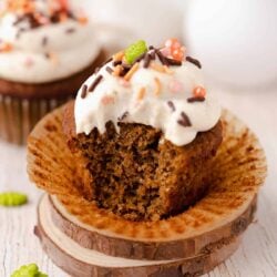 Spiced and frosted cupcake with a bite taken
