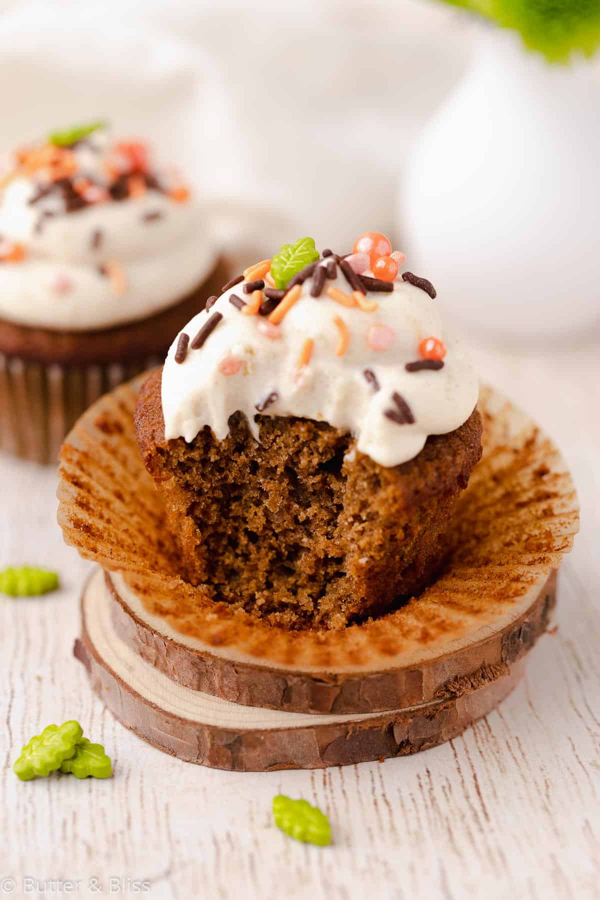 Spiced and frosted cupcake with a bite taken