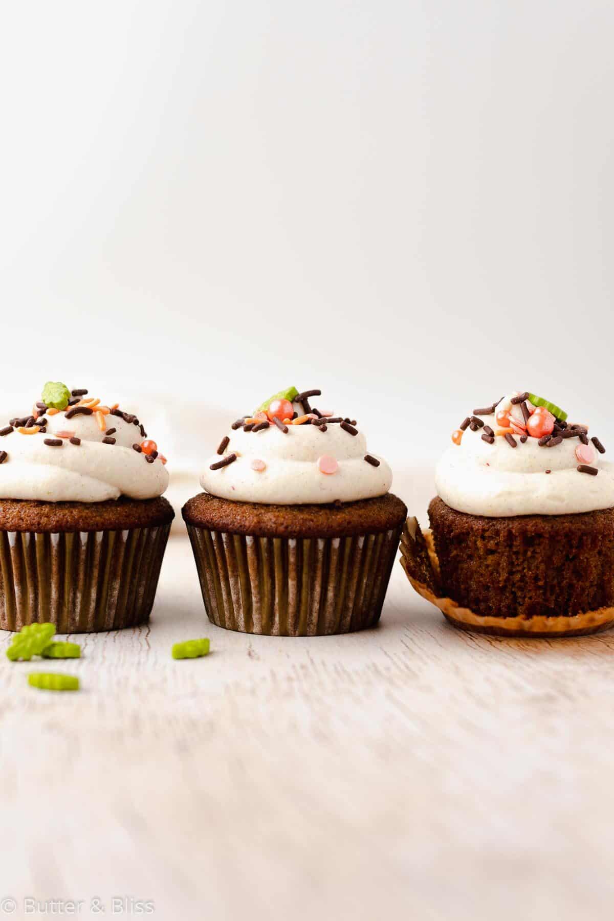 Row of frosted gluten free spice cupcakes