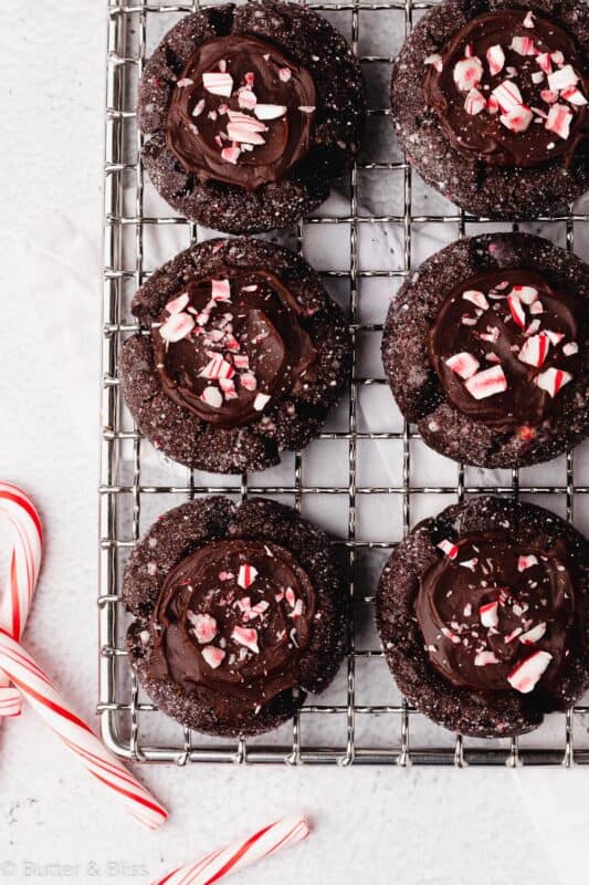 Chocolate peppermint thumbprint cookies on a wire rack