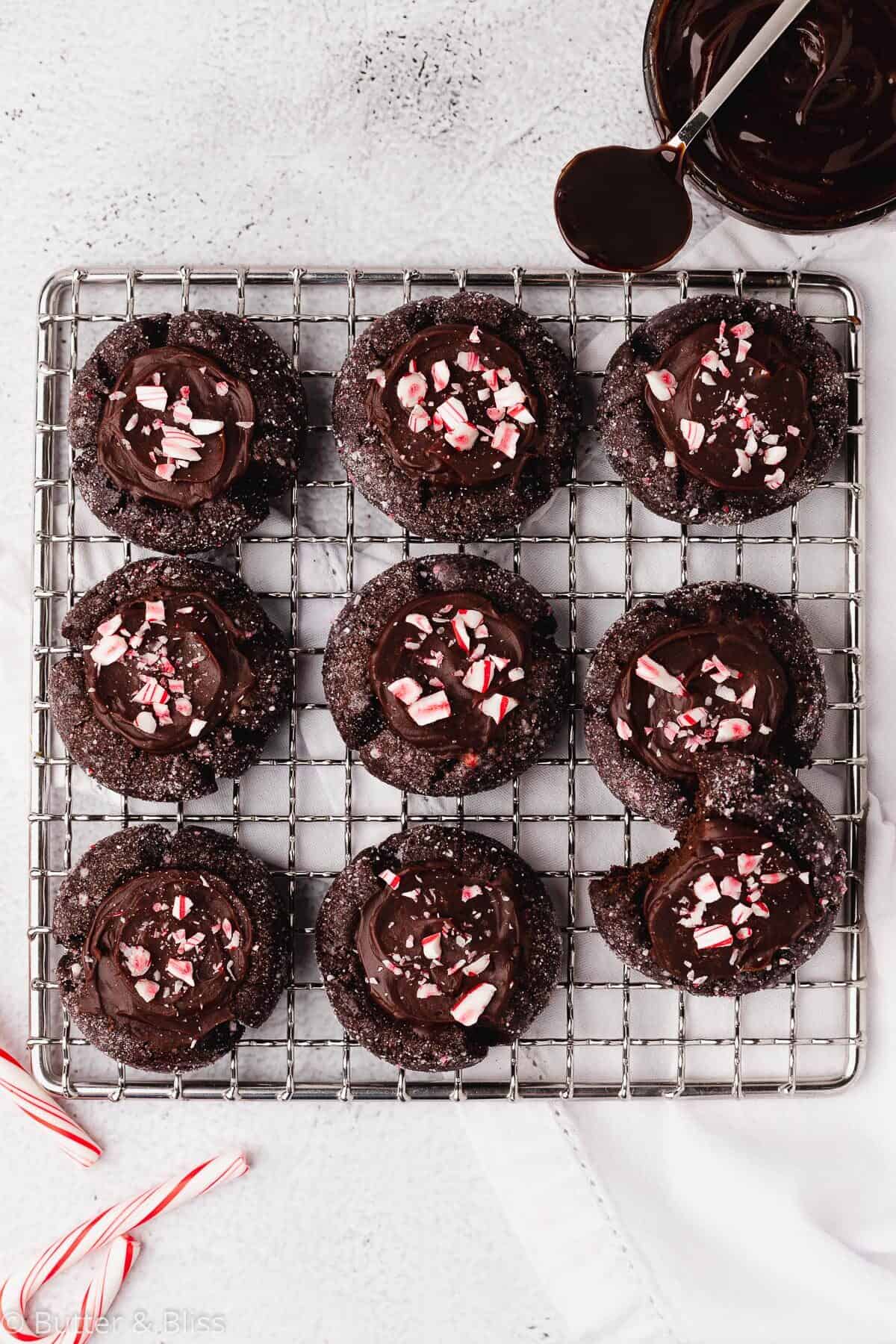 Peppermint chocolate thumbprint Christmas cookies on a cooling rack