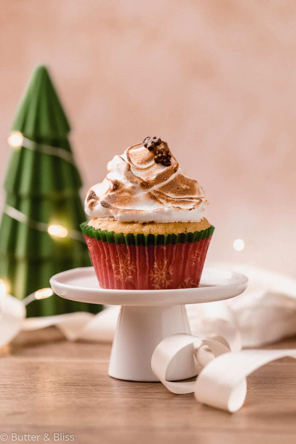 Single eggnog cupcake with toasted marshmallow frosting on a mini cupcake stand.